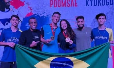 No centro da imagem, Adriano dos Santos e Melyssa Resende seguram medalhas do Aberto Dominicano Júnior de taekwondo