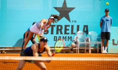 Luisa Stefani saca enquanto Gabriella Dabrowski aguarda na rede em jogo do WTA 1000 de Madri