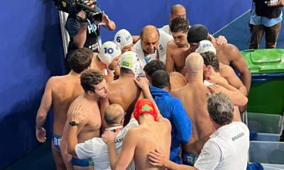 equipe polo aquático do Brasil forma círculo à beira da piscina em partida do Mundial de Doha