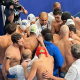 equipe polo aquático do Brasil forma círculo à beira da piscina em partida do Mundial de Doha